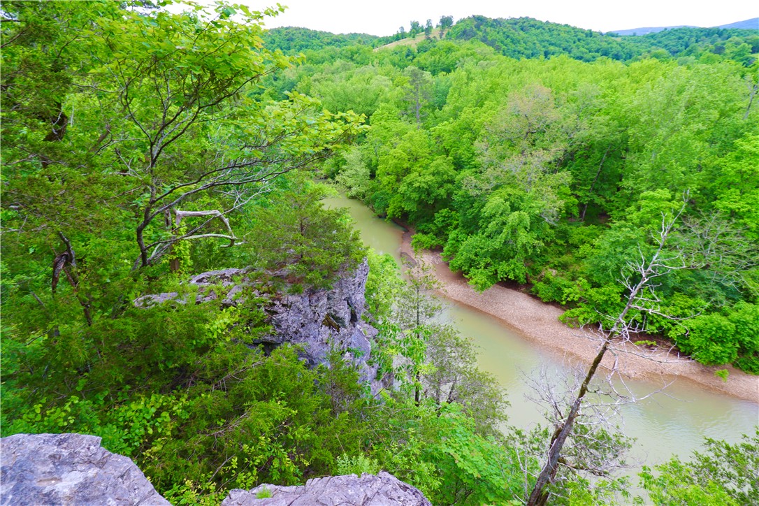 Overlook the Little Buffalo River on your own bluffs connected to 36.92 acres of beautiful green wooded land. Only 10 minutes from downtown Jasper and 2 miles from the Pruitt put in for the Buffalo River, this property is in a great location in the Ozarks. This land is a camperās dream with 2 spring fed ponds, bluff side river frontage, and 3 locations with hook ups for electricity, rural water and septic. Multiple build sites possible for cabins. Trails throughout the property make for great adventures all day long. This property features all of the amazing things Arkansas has to offer!