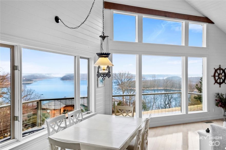 Enjoy panoramic views of Beaver Lake and the Ozark Mountains. The bright, beach-house-like living room features stunning views, deck access, vaulted ceilings, fireplace, and gorgeous wood floors. The kitchen has been completely remodeled with non-porous sea shell countertops imported from Italy, new flooring, cabinets, fixtures, and high-end appliances including double ovens. The luxurious master suite is a calming retreat with stunning views and deck access. The master bath has been completely remodeled with marble flooring and countertops, crystal light fixtures, and a spacious tiled master shower. New windows, paint, flooring, extensive landscaping, and more. Enjoy an abundance of Azaleas, Irises, Hibiscus, Stella lilies, Kanas, & Crêpe Myrtles. 5th bedroom suite possible with the additional ensuite room.Additional bonus room w/wet bar and tons of storage. 3 car garage with separate entrance to the downstairs living area. Less than 5 minutes to Prarie Creek Marina & approximately 10 minutes from downtown Rogers.