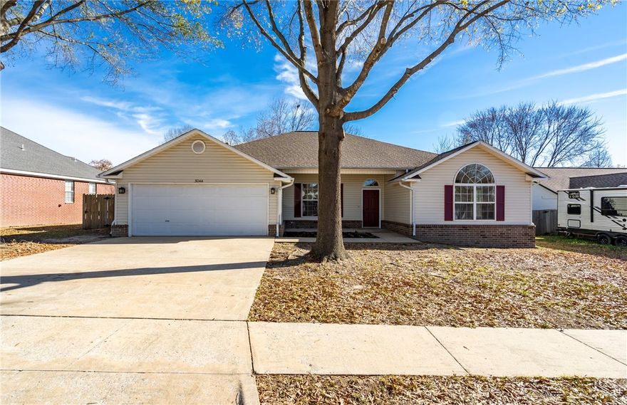 Completely updated and move-in ready, this 3-bedroom, 2-bath home with a dedicated office offers refreshed living in Fayetteville’s desirable Mount Comfort area. Renovations include new LVP flooring, fresh interior paint, updated trim, and new plumbing fixtures. The updated kitchen features new appliances, painted cabinetry, and lighting, opening to the main living and dining areas—ideal for everyday living and entertaining. The living room offers a cozy fireplace and ceiling fan. The primary suite includes an updated bathroom, while two additional bedrooms and a separate office provide flexible living space. Major upgrades include a newer roof and HVAC system. Outside, enjoy a new deck, groomed mature trees, and a private backyard. Located one block from Halcomb Elementary School and across from Clabber Creek Trail (future Razorback Greenway connection), with quick access to shopping, dining, and Northwest Arkansas amenities. Seller to offer $10,000 buyer concession at closing with accepted offer.
