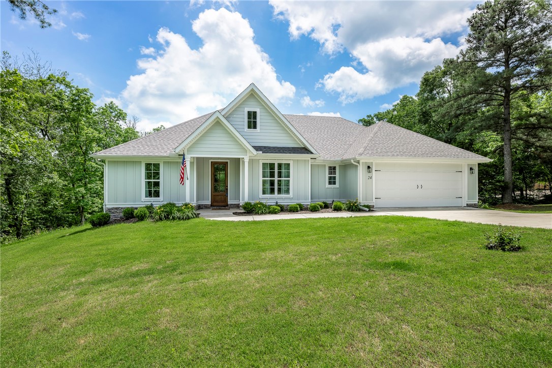 Better than NEW! (only 3 years young) This one level home has been meticulously cared for. Open concept floorplan with spacious living room with hardwood floors, lots of natural light and gas log fireplace. Kitchen features farmhouse sink, upgraded gas range and new quartz countertops. Primary suite is sure to please including hardwood floors, separate custom tile shower and freestanding tub, also the bath has direct access to laundry room! Enjoy nature overlooking the lush backyard from the covered patio with grilling area. 14x14 workshop is a dream for tinkering! 100% financing, $0 down payment, RD loan applicable - Call for details.