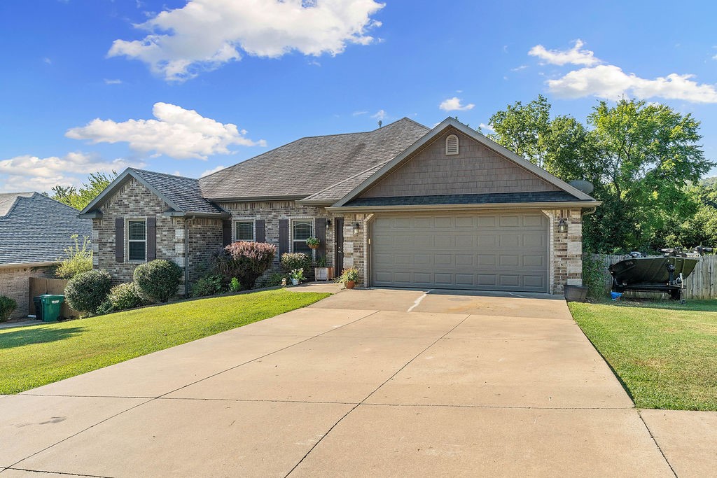 Welcome home to 183 Graystone St. This nicely maintained 3 bedroom/2full bath, split floor plan, brick home, is waiting for you. Nestled back in a small, well kept subdivision, it's a great place to come home to. This home boasts granite counters throughout, wood floors in the main living area and a double sided fireplace, that you can enjoy in the living room and kitchen. It has a spacious kitchen with double pantries and plenty of counter space. The dining area is open to the kitchen and will accommodate a large table. The primary suite features double sinks, double closets and a jetted tub. The back yard is fenced and has a huge covered deck for entertaining. It is just a 5 minute drive to West Fork Schools and only 12 miles to be on campus at the UofA. This home is a must see!