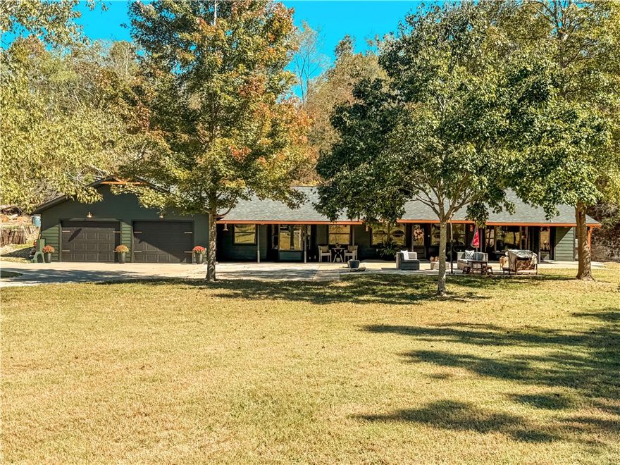 Welcome to your personal paradise! Sit outside on the patio and listen to the waterfall flow and watch all the wildlife roam.  This beautiful home sits on 6.76 private acres with 2 ponds, a year round creek running through it, mature walnut trees and fruit trees . Property has an outbuilding/barn and an attached insulated workshop with a half bath. The home has 2 living areas, a loft that was closed in and could be a small bedroom or a great playroom, newly remodeled master bedroom with custom closet and newly remodeled 2nd bedroom. The home has 2 HVAC units, one being an energy-efficient Geothermal unit, installed in June of 2022 and a new Electric unit installed in June of this year. Other upgrades include a new roof, new gutters, new well house and all new well equipment, new LP smart siding, just to name a few.   A full list of upgrades is attached.  Interior photos to be added soon.