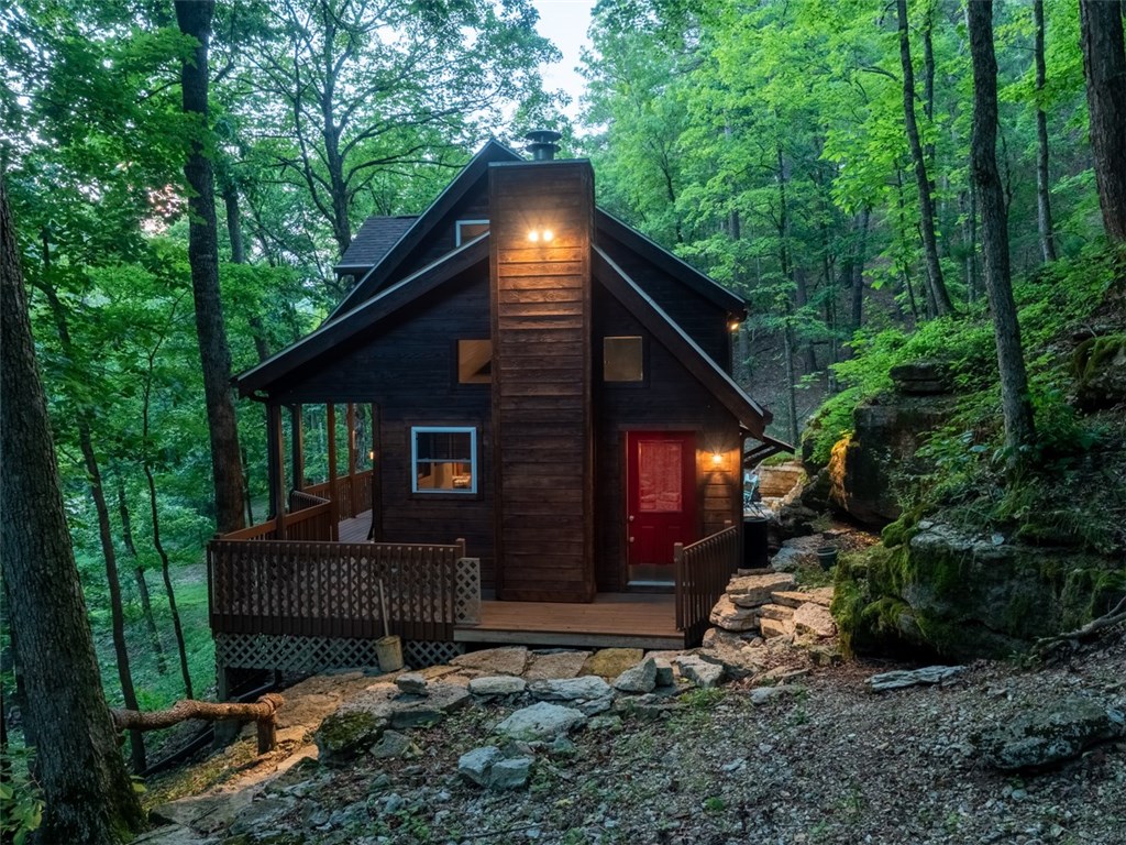 Captivating seclusion in the heart of Eureka! This hideaway oozes of rustic charm and is walking distance to the main streets of Eureka Springs. Sitting at the base of Little Lake Eureka and surrounded by limestone bluffs this 2 bed/2 bath is the perfect place to call home. The over-sized master bedroom is equipped with a large jetted tub and walk in shower. Beautiful hardwood floors, pine door and window frames, hidden stained glass and clerestory windows paired with aesthetically pleasing paint make this a permanent vacation.