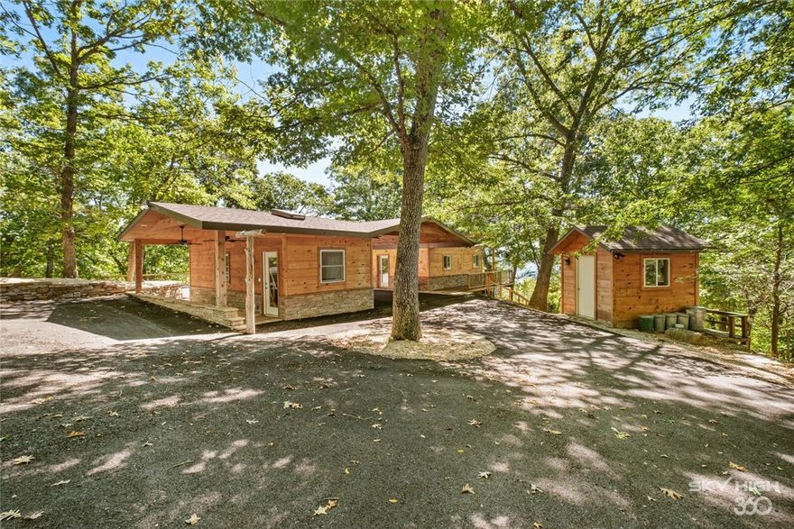 An absolutely one-of-a-kind, completely remodeled, lake front property located on Beaver Lake. The home has an open floor plan with views of the lake from every room, a designer kitchen, a master bedroom with wrap-around windows with lake views from all angles, that features a cedar-lined walk-in closet and a full 7-foot bathtub and a separate shower. The back deck is accessible from every room.
The property has direct dock access from either steps directly from the house, or down a private driveway. The dock includes a swim platform, 8 boat slips in two private and seperate docks, and 2 lifts. The property includes approximately 10 acres. In addition to the main house, the property includes a completely remodeled mother-in-law unit that has loft-sleeping, its own separate kitchenette, a full bathroom and shower, and its own private porch.  Also, immediately adjacent to the main house is an 8 by 10 office space, for those who need to work while at the lake.