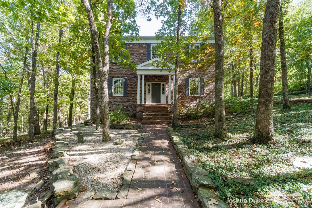 Phenomenal estate-like property located on 2.3 acres in Central Fayetteville. ~3,500 heated sq ft of living space in this quaint 2 story brick home that is surrounded by walkways, ivy covered trees, and natural maintenance-free landscaping. Spaces include 3 bedrooms, 4 full baths, living, dining, EIK, office, and sunroom. Amenities you will find are Calcutta Marble in master bath, plantation shutters, 20 yr cedar shake roof, operable transom windows, wide plank wood floors, brass door knobs, solid Douglas fir doors, 2x6 walls, and a 600 sq ft deck.
