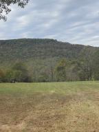 A large secluded private 81 acre tract deeded 1/4 mile to pavement just south of Harrison with beautiful mountain view from a pasture homesite. Water meter available on site and power back close to main property. Old log road through much of property and another 15-20 acres could be cleared for more pasture if desired. 2 ponds on property with one stocked with catfish. Perimeter fencing and good road into main property. Priced to sell.