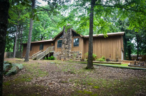 COMFORTABLE COTTAGE UPDATED WITH HANKE BROTHERS SIDING AND ROYAL WINDOWS, TWO BEDROOM, TWO FULL BATH HOME WITH ROCK FIREPLACE, HEATED AND COOLED SUNROOM FACING CORP PROPERTY, SHOP, STORAGE, DECK READY FOR RELAXING OR ADDING A POOL.TIME TO ENJOY LIFE!!