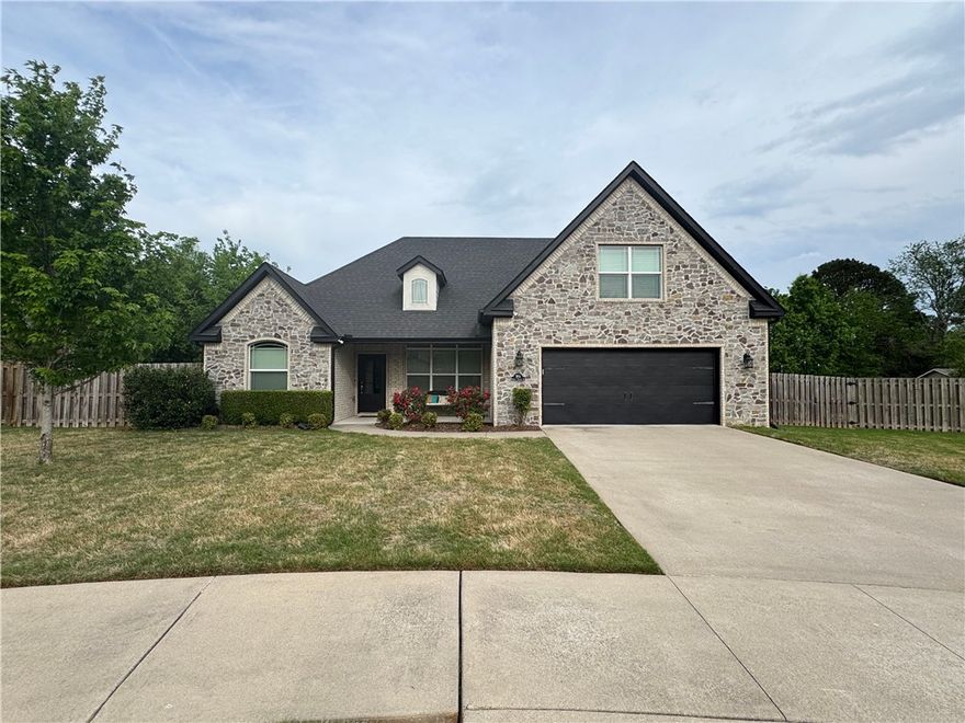 This beautiful property is situated in a quiet subdivision, close to schools, parks and trails, and Lake Fayetteville. Although located in a neighborhood convenient to both Springdale and Fayetteville, there is a large field directly behind the yard giving the perfect balance of convenience and seclusion. Enjoy the open-concept living, kitchen, and dining areas, perfect for entertaining or spending quality time. In addition, the private office provides a quiet workspace. The kitchen is equipped with updated, stainless steel appliances, ample storage, and a breakfast nook. The home features four bedrooms and three full bathrooms. The primary suite has an ensuite bathroom, with a spacious shower and jacuzzi tub for relaxing. The backyard is a private oasis, complete with a deck and plenty of space for outdoor activities. Within the past year, there have been numerous upgrades to the home including upsizing the A/C, as well as the kitchen appliances. The roof was replaced in July 2025.