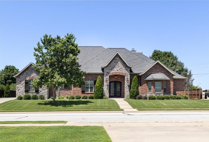 Custom one owner home in Enclave subdivision. The gorgeous landscaping draws you in before you open the front door and fall in love with the wood floors and crown molding throughout. Formal office with exquisite wood ceiling is perfect for working at home. Living room features a fireplace surrounded by built-ins as well as a wall of windows beaming natural light. Stunning kitchen with large granite island, white cabinets, stainless appliances, gas range, coffee bar and huge walk-in pantry. Primary bedroom on main level with ensuite featuring dual vanities, custom tile shower and room sized walk-in-closet. Two more good sized bedrooms share Jack and Jill on other wing of home. Teenagers dream gigantic bedroom is upstairs with theatre screen and all theatre equipment. Oversized garage can actually park 3 cars. Large laundry room and powder room as well. Relax with the family outback under the big covered patio with expansive patterned concrete, wood burning fireplace and TV. Built-in storage room for outdoor tools.