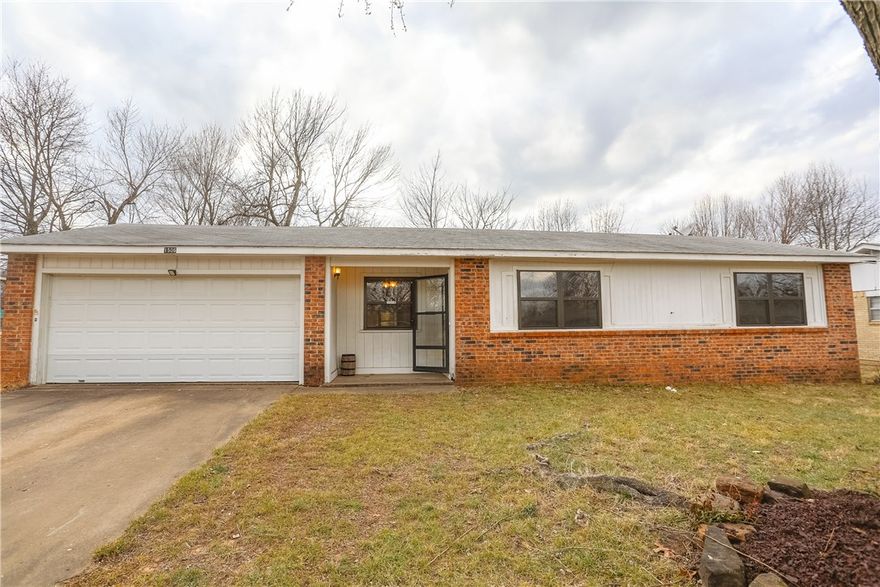 Subject to Probate Approval. This 1974 1-Story, 3-Bedroom, 1.5-Bath, brick and frame sided home with 2-car attached garage situated on good sized fenced yard with a covered front porch. Smaller in size, this home is located on a busy road with easy access to Elm Springs Rd near I-49, this home could be a good starter or investment opportunity as a rental as a fixer upper. Eat-in kitchen with cabinets, some counter-top space and no range, laundry area in garage, storage shed conveys and covered back patio.