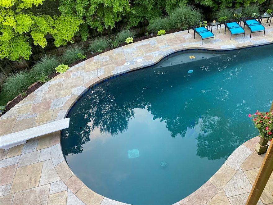 Exquisite Bentonville retreat offering 5 bedrooms, 4.5 baths, and 4,432 sq ft across three thoughtfully designed levels. Chef’s kitchen features custom wood cabinetry, an oversized pantry, and a beverage cooler. Main-level primary suite includes private deck access overlooking a wooded backyard oasis. Additional highlights include a private office, craft room, weight room, and walkout basement with kitchenette—ideal for entertaining or guest space. Outdoor living shines with a heated pool, waterfall hot tub, wood-burning fireplace and covered dining area. Prime location less than 0.5 mi to I-49, 1 mi to the new Walmart Home Office, and within 3 miles of Downtown Bentonville, Crystal Bridges, trails, parks, and top-rated Bentonville schools. May 2024 updates include a new roof, gutters, garage door, and AC. Seller offering $2,000 carpet allowance and $6,500 preferred lender credit.