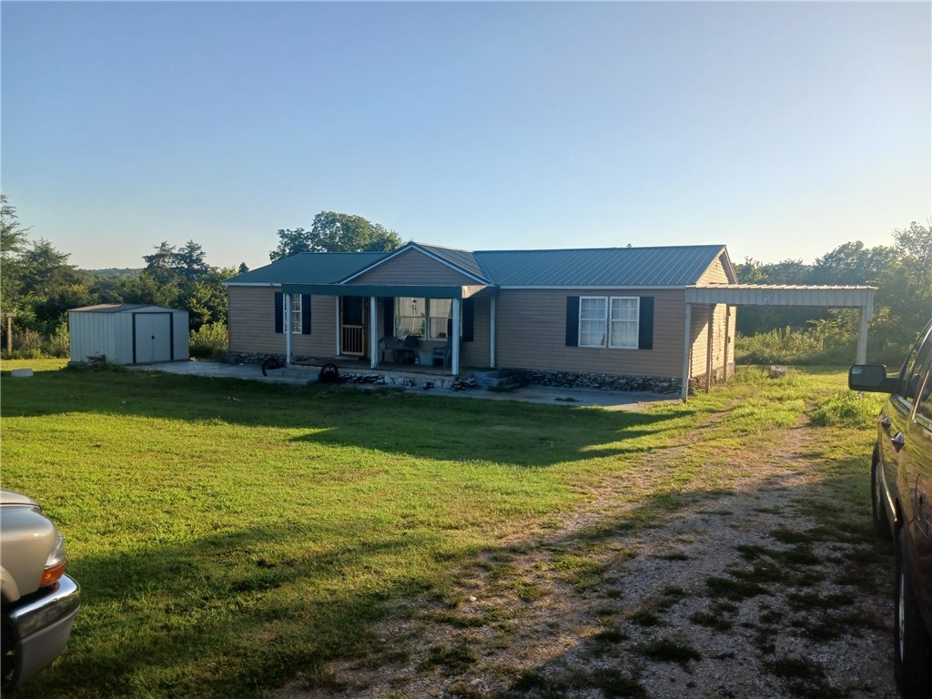 Beautiful 9 acre setting with views of Boat Mountain and only a short drive to the Buffalo River for canoeing and outdoor fun. Home is a manufactured, well maintained home with 1456 sq ft that has been updated to a rustic design. Bedrooms all have walk in closets. Great kitchen with a nice pantry. Large metal building currently has a workshop with three garage doors in the back and gift shop. Gift shop has kitchen and bathroom; space could easily be converted into an apartment for airbnb or MIL quarters. Gift shop is on it's own septic. Property is a good spot for hunting enthusiasts. County trash is available. Property also has chicken coup and garden spot. A wonderful cozy, country spot to call home.