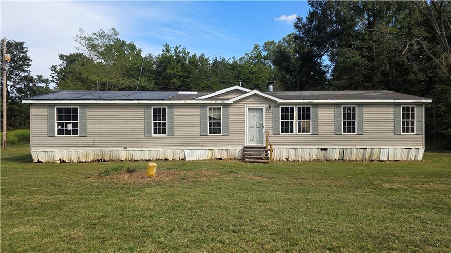 Set on three spacious acres in Dardanelle, AR, this mobile home offers three bedrooms and two bathrooms, perfect for those seeking room to grow or a peaceful retreat. The property’s generous lot invites dreams of gardens, play spaces, or expansion, while the home itself presents an exciting opportunity for renovation. Though it will require repairs and updates, its layout offers functional living spaces and potential for customization. Ideal for handy buyers or investors ready to transform a property with great promise into a personal haven in a beautiful rural setting. This property is being sold as-is, property is lender-owned and US Bank is making no representations or warranties.
