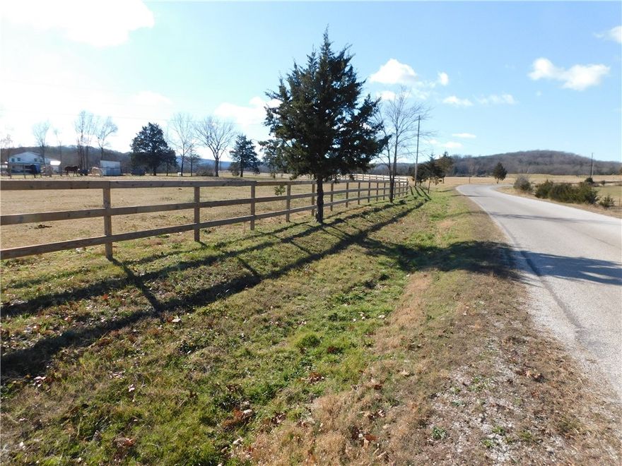 Level 2.37 Acre lot, black top road frontage, electric, public water bordering property. Partially fenced with brand new 3 rail wooden equestrian railing. Pasture ready for horses with small shed. Private building site, views of the mountains, park like setting, gorgeous sunsets and starry skies. 8 minutes to highly rated Elkins schools. 10 min to shopping, doctors, restaurants. The great outdoors at its best yet close to town for all the essentials. Easy access to Washington regional Hospital approx. 30min! Straight shot (20 min) to the University of Arkansas, Fayetteville. Subject to lot split completion. Agent Owned.