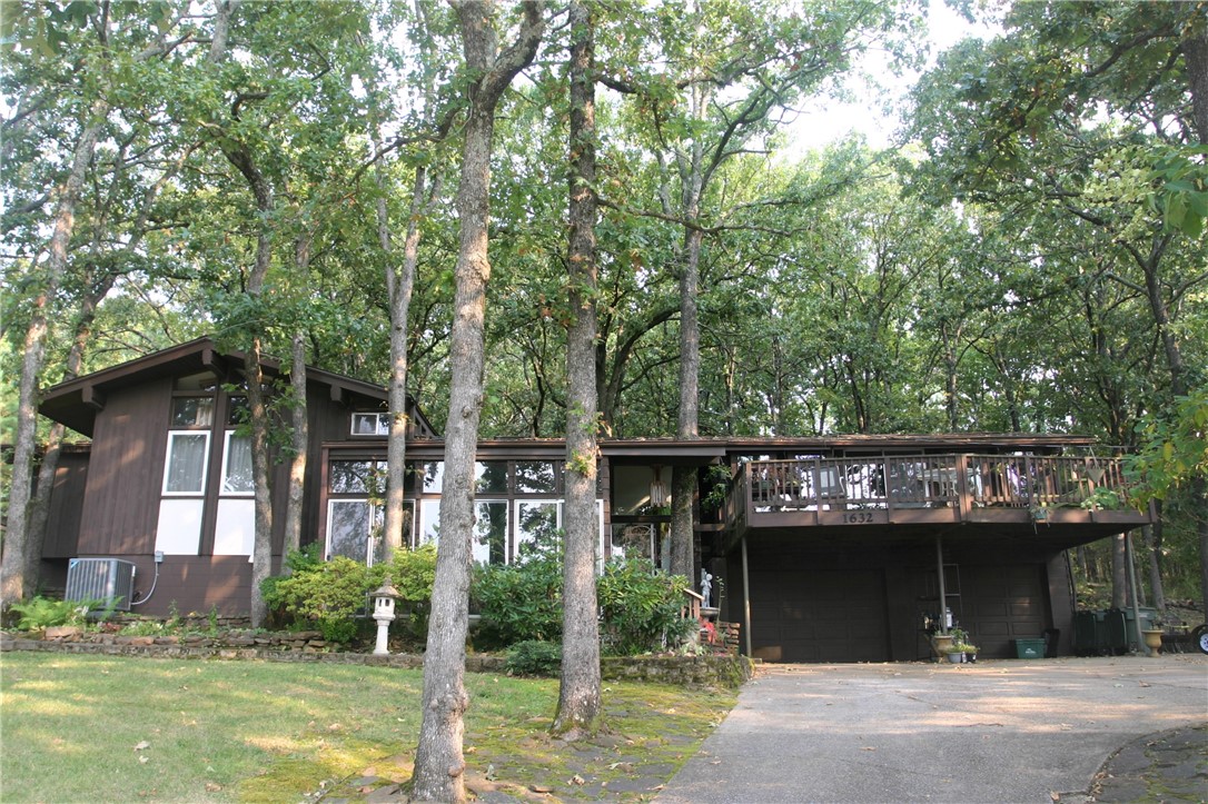 Home designed by a student of architect Fay Jones. It incorporates many of the design features found in his homes such as vaulted ceilings, gabled roof with wide overhanging eaves, long hallway extending the length of the home, and large vertically oriented windows in the family room that give an awareness of light and the surrounding nature. Simplicity of construction, incorporation into the site, and attention to crafted detail show in the construction. Adjacent house is available MLS#1200654 as is 3.32 wooded acres directly north of this property MLS#1200660
Only 2.5 miles from the UofA and 2 miles from the upcoming Windgate Art and Design District.