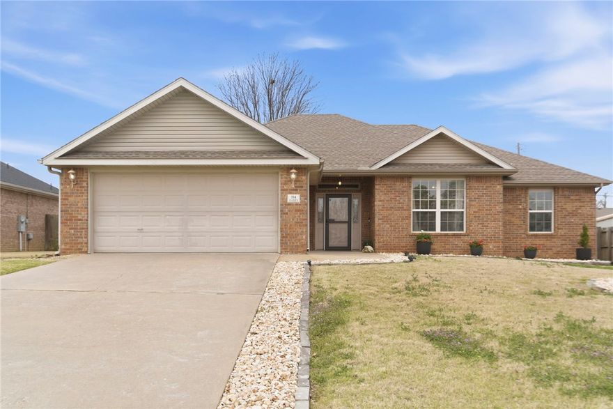 Bright and inviting right when you walk through the front door, well-maintained, and ready for its next owner, this home offers an inviting layout with soaring cathedral ceilings that enhance the sense of space in the main living area, anchored by a cozy gas fireplace. The kitchen provides excellent prep space with pantry, abundant cabinetry, and a window over the sink that brings in natural light. Step outside to a generously sized covered patio overlooking a spacious, level backyard—ideal for entertaining or everyday enjoyment. Recent improvements include a tankless water heater, HVAC system with UV air purification, 2022 roof, updated garage door motor with new rollers, and a newer dishwasher, along with smart features like a Ring doorbell and Google Nest. Conveniently located near I-49 and Highway 102 with quick access to downtown Bentonville, this home blends comfort, functionality, and location. Refrigerator, washer, dryer convey.
