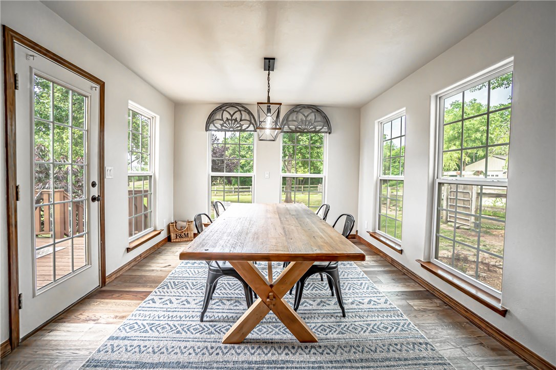 SHOWSTOPPER! Charming, recently renovated farmhouse near all the necessities - shopping, restaurants, entertainment, and so much more! Pond, home, and 1,000 sq ft steel truss shop perfect storage for all your toys and/or parking located on over 4.5 acres! All new flooring and granite countertops throughout, fixtures and interior paint (see supplemental docs for complete list of upgrades). Eat-in-kitchen is a dream with new copper sink, granite counters, and ample amount of cabinet space. Enjoy the wooded, peaceful views from the dining room with large windows on all three walls. Retreat to the master suite - enormous walk-in shower with drying area, double heads and a custom vanity with makeup counter, vaulted ceilings, and large walk-in shower. All bedrooms are carpeted with large walk-in closets. Relax outside in the peaceful, country setting - spacious covered front porch and back deck. Welcome home!