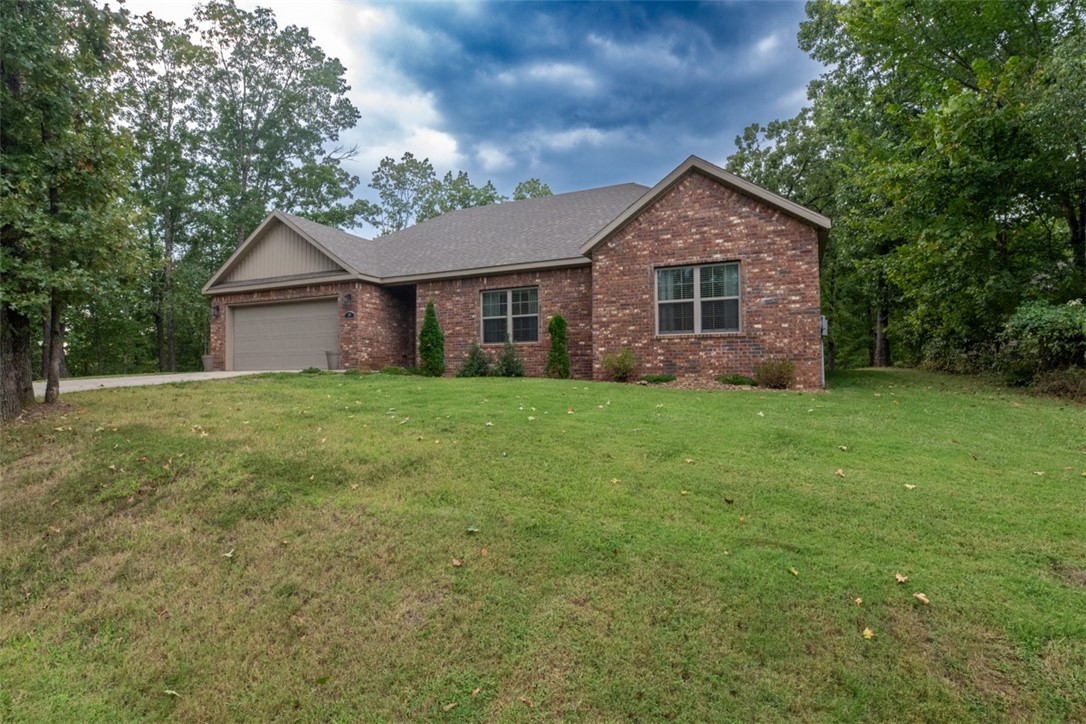 Welcome to 39 Skipton Drive, a nearly new home built less than three years ago, set on a double lot in the heart of Bella Vista. The additional lot is perfectly set up for a family to enjoy the outdoors—whether that’s play space, gardening, or simply soaking up the natural surroundings. The renowned Back 40 Trails are accessible right on your street, perfect for mountain biking, hiking, or leisurely walks. Both Lake Ann and Lake Brittany are less than 3 miles away, offering fishing, kayaking, and beautiful views just minutes from your door. Inside, the home features a bright open layout, a modern kitchen, and comfortable living spaces ideal for both relaxing and entertaining. The primary suite provides a quiet retreat, while additional bedrooms offer flexibility for family, guests, or a home office. Step outside to enjoy the peaceful wooded setting from your private deck and experience the best of Northwest Arkansas living every day.