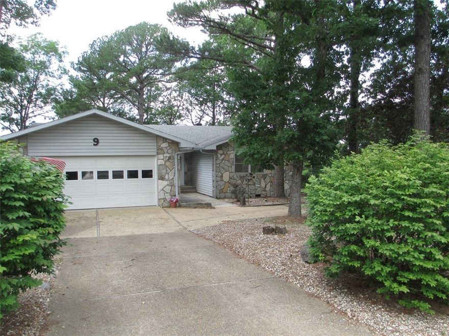 Move in ready Ranch home is waiting for YOU!! Well maintained 3 bed/2 bath home on big corner lot with circular drive & additional parking including an RV space w/electric hookups.  Hardwood floors gleam throughout the home, ceramic tile in the baths kitchen & laundry make clean up a breeze.  Open living/dining space is complete w/ ceiling fan, woodburning stove to chase the chill, sliding doors that allow access to the sun room (appr 125 sq.ft. not counted in overall sq.ft. & large covered deck. The kitchen has a plethora of cabinets, counter space, & all appliances just 4 years old. Laundry area is complete with newer appliances, mop sink & large pantry. Low maintenance landscaping & bonus raised gardening beds in the back yard.  Bring your fur babies to enjoy the doggie door access to the large fenced area at the side & back of the home. Extra storage in crawl space  Enjoy all the amenities Holiday Island offers, golf courses,  pool, marina, tennis, club house, restaurants, shopping,  Table Rock Lake & more!