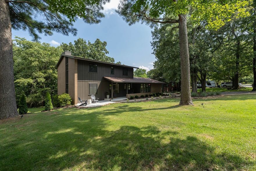 Beautifully renovated mid-century home sitting on top of Mount Sequoyah with treehouse views on a flat, walkable street.   It features an expansive kitchen with an adjacent beverage bar and soapstone countertop. The sunroom is a great dining area located just off of the kitchen. There are two large living room spaces each featuring fireplaces. The rooms are flooded with natural light and scenic views.  
Enjoy secluded backyard views from two decks or sit by a fire pit under more than 100 string lights.  
It is a downhill walk to Root Elementary with close access to the University and the downtown historical district.