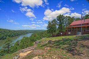 If you are looking for a nice getaway or if you are an investor looking for an airbnb that will stay booked check out this unique cabin overlooking Piney Creek. The cabin itself features just over 1500 sq feet with 2 full bedrooms, two full baths and a loft that will sleep 4 comfortably. Most of the furniture and decorations will stay with an offer acceptable to the Seller. There is a full kitchen that is open to the large living area. There are two garage doors that open up to the wrap around covered deck for entertaining. There is a series of decks that make their way down the bluff that features a bar, pergola and a hot tub. All the while encompassing the breathtaking view of Piney creek. You will love exploring the 3.35 acres and relaxing in this fantastic property.