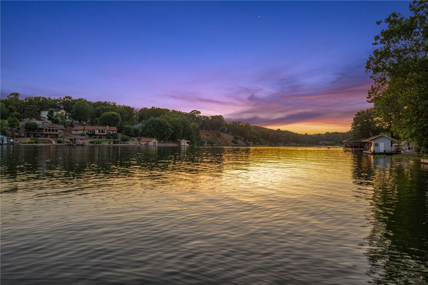 Loch Lomond PARADISE with a waterfall! Short walk to private covered boat dock and VIEWS FOR DAYS! Two levels of custom finishes and upgrades including lake views from nearly every room. Property offers 4 bedrooms, 3 full bathrooms, primary includes ensuite bathroom with oversized soaker tub, walk-in shower and two large closets with passthrough to laundry space. This one owner home has been well maintained with upgrades including kitchen remodel with appliance upgrades plus convection oven and induction stove, new roof on home and boat house, new water heater, Anderson patio slider doors,  carpet, windows, fixtures, and sun/blackout shades. Basement level offers wet bar, living room, bedroom with full bath, a multi-purpose room perfect for fitness, bunks, or hobbies AND over 500sf of storage space! This isn't even the half of it! This home is the gift that keeps on giving!