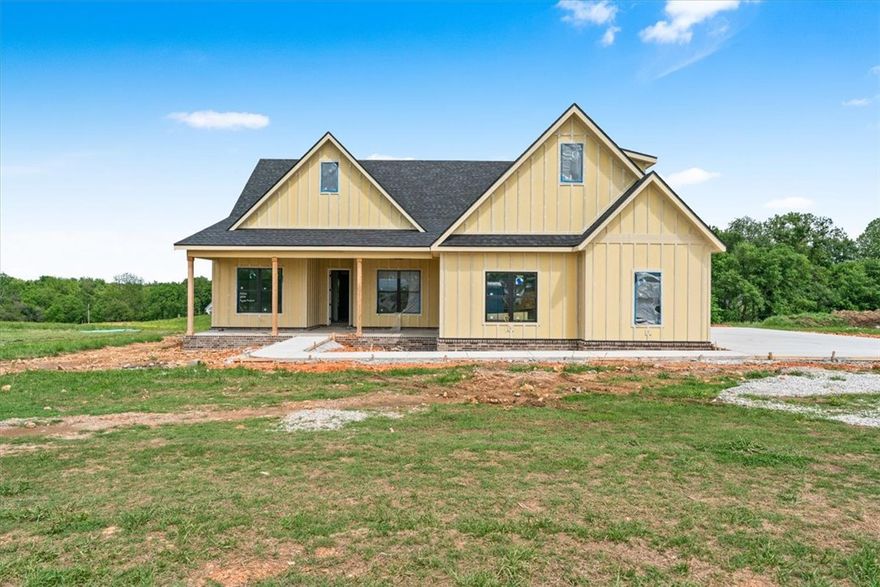 Look forward to coming home to Springdale's newest subdivision, Magnolia Meadows off Harmon Rd
Fayetteville address, Springdale Schools, near Tontitown. Once acre lots, 3 car garage, 3200-3800 sq ft
homes planned. Just getting started but this home has 4 bedrooms, 4 bathroom, study and media room. Front porch, back deck and all the spaces you need. Sprinkler system will be installed for the sodded areas of the yard as well.  Come check it out.