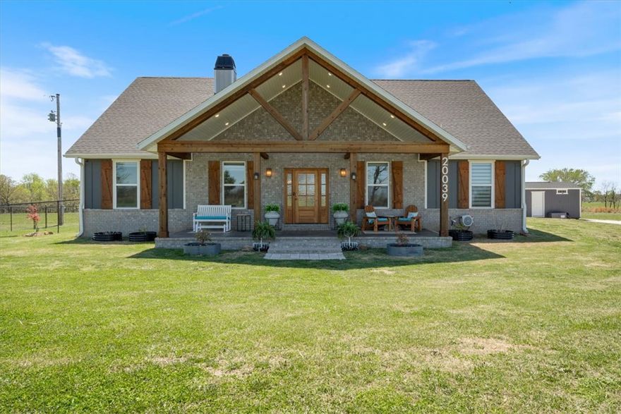 Own your piece of heaven on earth with this stunning custom-built home on 10 beautiful acres! Step through oversized double doors into a bright open-concept living area. The showstopper kitchen features a copper farmhouse sink, quartz countertops, hickory cabinets, walk-in pantry, refrigerator, and top-tier appliances. The primary suite offers double vanities, a freestanding tub, walk-in shower, built-in laundry storage, and a custom walk-in closet. Enjoy the screened porch, cozy wood fireplace, sunroom (perfect for office or bonus space), fenced yard, storage shed, electric car charger, and whole-home generator. Custom blinds and a beautiful leaded-glass sliding barn door add elegant touches throughout. This immaculately clean home sits on open acreage with a pond, second water tap, and two 5-acre parcels—ideal for a horse barn or second home.