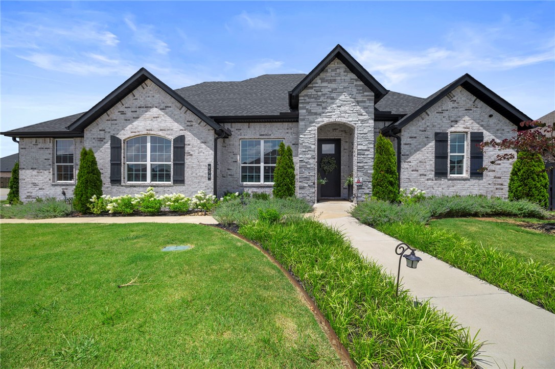 Welcome Home to Comfort, Style & Peace of Mind! Situated on a beautifully landscaped corner lot, this home blends comfort, function, and joy. The professionally manicured yard with irrigation and ambient lighting creates a welcoming first impression. The spacious three-car garage has sealed flooring and is equipped with custom cabinets. Additional attic flooring ensures you're never short on space. Inside, wood floors run through all bedrooms, and custom window treatments and plantation shutters add timeless style. Tinted windows throughout enhance privacy, energy efficiency, and security. The primary closet features a custom organization system designed for ease and calm. Every detail has been thoughtfully chosen, including a state-of-the-art security system with indoor and outdoor cameras for peace of mind. Whether you're enjoying quiet mornings or hosting loved ones, this home is a retreat meant for meaningful living. More than a house, this is a place to grow, gather, and thrive!
