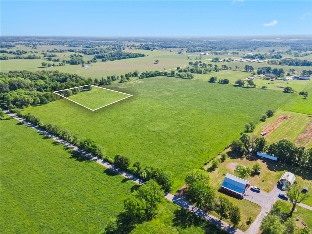 Just 10 minutes from the Northwest Arkansas airport, discover an exclusive opportunity to claim 3.77 acres of pristine, flat land where elegance and tranquility meet. This rare gem offers uninterrupted views of both sunrise and sunset, creating a breathtaking backdrop for a lifestyle of refined comfort and serenity. The land stretches wide and open beneath a vast sky, inviting you to dream without limits. Imagine a custom estate tucked into the peaceful landscape—grand entrances, sleek architecture, manicured grounds, and sophisticated outdoor spaces designed for hosting under the stars. Whether you’re envisioning a modern sanctuary or a timeless retreat, this land provides the foundation to build your legacy. Privacy, beauty, and convenience converge in one exceptional location—close to everything, yet far enough to feel like your own private escape. Your future deserves a setting this extraordinary. Let luxury begin here.