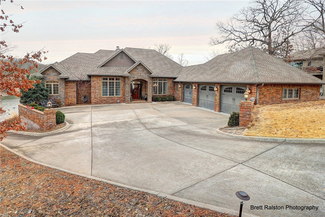 Spectacular custom lake front home with a fabulous view. This home is quality constructed and beautifully detailed. Vaulted ceilings. wood floors & open floor plan. Gourmet Kitchen, fabulous island with gleaming granite, built in micro, double ovens. Service area w/butlers pantry, coat cubby, walk in pantry & charging station. Master suite, hers & his closets, laundry area. Huge game rm w/floor to ceiling windows. Every bedroom has its own bath. Large storage area. Private dock w/lift. Geo therm heat