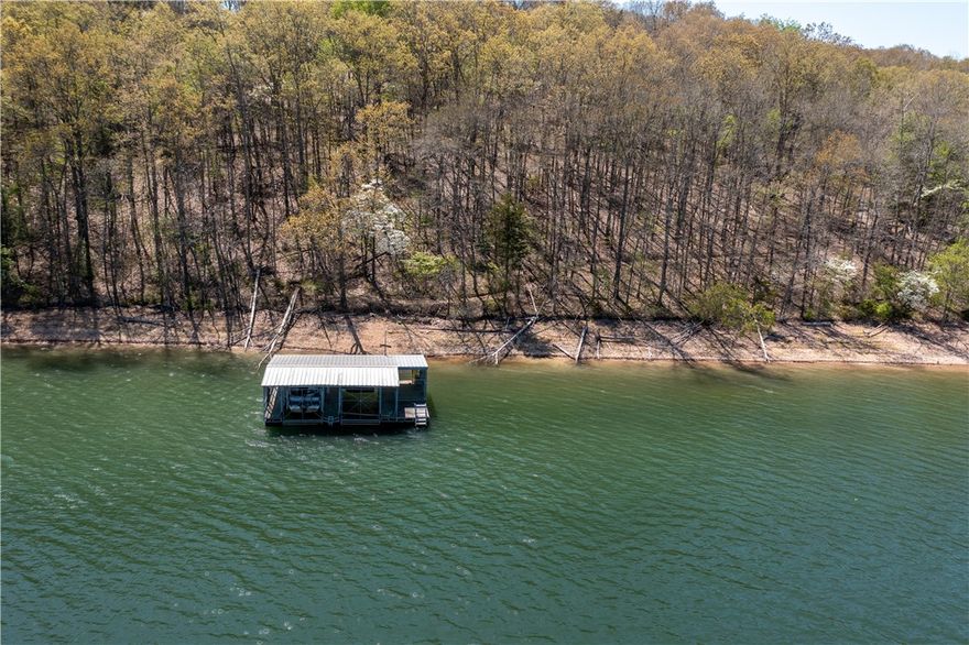 ARCHITECTURALLY INSPIRED LAKEFRONT! Private Prairie Style Home influenced by E. Fay Jones and Wright design on 13.55 acres is located within 6 miles to Downtown Rogers, shopping and restaurants! Architect-Kim Fugitt! Your adventure begins with the drive from gated entrance to a covered front door portico and down paved nature trail, past the pond, to the lake and your private 2-Stall Boat Dock with a lift and swimming deck! Exterior offers cedar and brick, total of 7 car garages, wrap-around deck to enjoy your lake view, in-law apartment & 2,000 sqft insulated outbuilding. Interior features entryway, updated kitchen with granite tops, abundance of cabinetry, stainless appliances and eating area with lots of natural light! Large living room with wood-burning fireplace, owner’s suite with full bath with brand NEW walk-in spa, bidet, walk-in tiled shower and dual granite vanity, walk-in closet & screened-in porch, downstairs with 3 bedrooms and large family room. List of features/updates attached! Call TODAY!