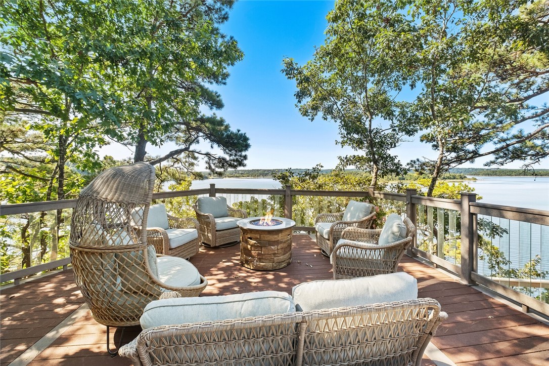 Picturesque Beaver Lake Estate gracefully poised along over 450 feet of breathtaking rock shoreline. This updated home sits on a 0.86 private acre featuring 5 bedrooms, 5 full, 1 half bathrooms & multiple living spaces with panoramic views & access to alfresco living from every room. Main level includes a well-appointed great room, gourmet kitchen with copper vent hood, 2 master suites, office & spacious laundry room. Lower level offers 3 Bedrooms, 2.5 baths plus additional large living & recreational area with storage space. This home is perfect for entertaining inside & out, with open floor plan, cupola with private patio & over 4,000 sq ft of expansive tiered composite decking with glass balusters, hot tub & breathtaking lake views. 4-car garage, large workshop/exercise space & abundant storage. Private co-owned 24x26 boat dock with 10x20 slip & lift with swim deck included. This home is conveniently located just minutes from downtown Rogers & State Parks close to trails & more. No short-term rentals allowed.