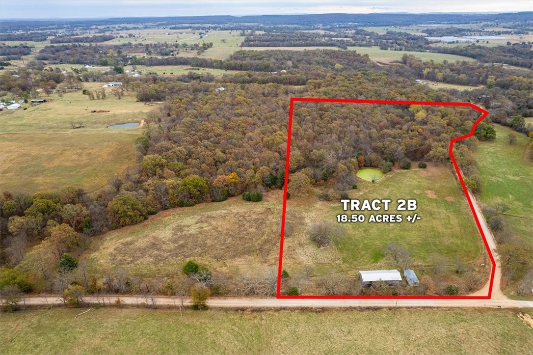 Escape to 18 acres of serene countryside, perfect for creating your private hunting retreat or exploring the outdoors. This property features a picturesque pond surrounded by mature woodlands, making it a haven for wildlife and nature lovers. Outbuildings are included, offering additional potential for storage or other uses. Conveniently located near Siloam Springs, it offers the tranquility of rural living with quick access to nearby amenities. Whether you're seeking a peaceful getaway, a hunting paradise, or land for your dream home, this property delivers endless opportunities in a stunning natural setting.