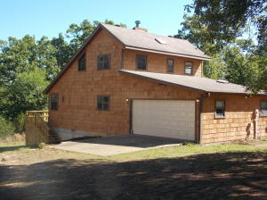 Gorgeous Cedar Shake Lake House!! This beautiful 3 BR, 2 BA home has 485 ft of Corp frontage. You have great lakeviews in the fall and winter and peek-a-boo views in the summer. New decks on the back of the home for those great cook outs. This home is practically new on the inside. It has all new flooring, including some gorgeous hardwoods, new skylights and all new paint. Property also has an added bonus of a mother-in-law studio cabin (or man cave) that includes a full bath, laminate floors, a window unit heat pump for air and heat and the mini-fridge and microwave will convey with it. There is also 22 x 40 shop that includes a 2 car garage and workshop/storage area! All of this on 3.45 +/- acres.