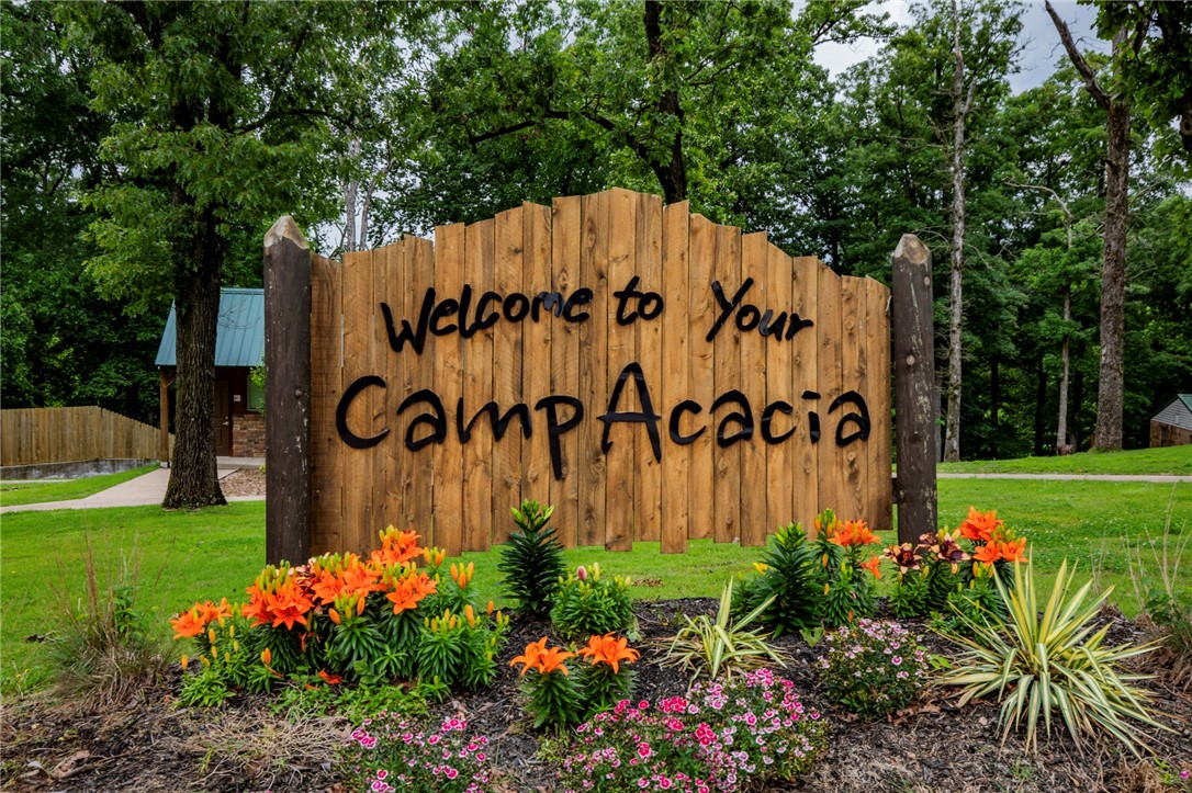 Located in Gentry AR, this 50-acre camp is now available to purchase. Camp Acacia opened in 2021 as a camp for kids with disabilities, hosting other types of summer camps & corporate retreats. This rare property has state of the art facilities to accommodate up to 160 campers, staff, & volunteers. The property contains 50 acres, of which 35 acres are fully developed & 15 acres are available for exploring, bike trails, or future development. The camp amenities includes a swimming pool, playground areas, fire pit area, baseball field, basketball court, zipline, & ropes course. The campers can also enjoy a 2 acre spring-fed lake for fishing & kayaking. Accommodations include 9 different climate-controlled sleeping quarters, clinic, dining hall with commercial kitchen, & great hall for special events. There is also a 1,900 sqft home & shop included. All furniture & equipment will be sold with property.
