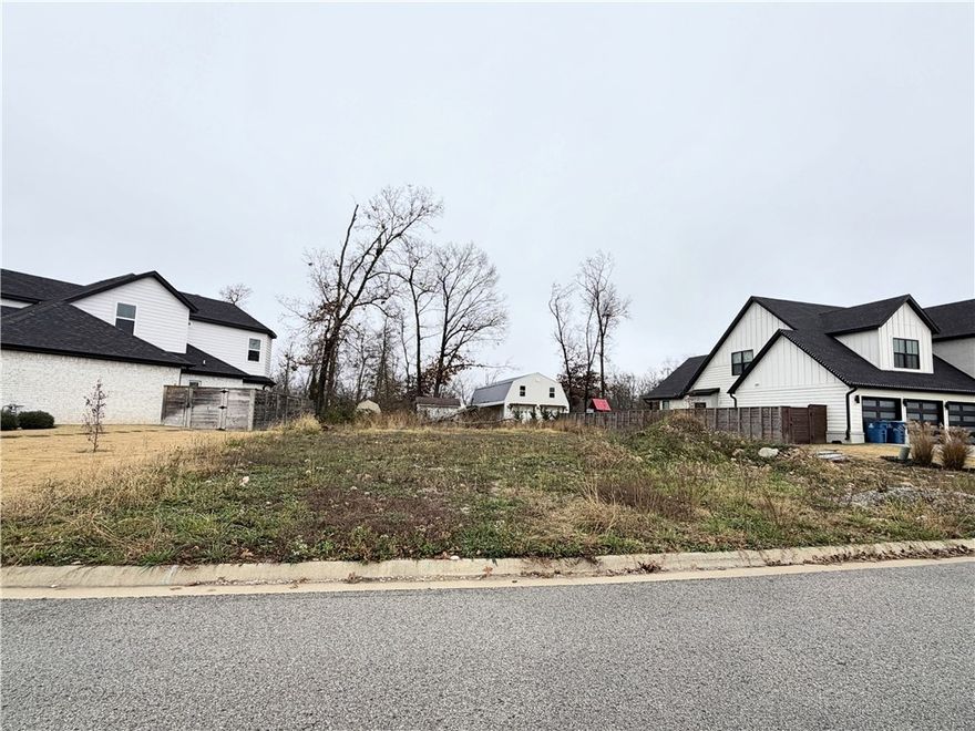 Autumn Hills is located about 10 minutes from downtown Bentonville. It is an upscale and relatively new community, featuring custom-built homes and vacant lots for sale. The entrance to the neighborhood is on SW Autumn Hills Road, off SW 28th St. The community includes both completed homes and available building lots. A homeowners association (HOA) fee is $250 annually. Residents have easy access to the Crystal Bridges Museum of American Art, extensive trail systems, and local parks. It is also close to the Walmart Home Office. No Seller Property Disclosure on vacant lot. Owner is related to a licensed real estate agent with Grandview Realty LLC. Taxes are based on the land only and will increase when re-assessed.