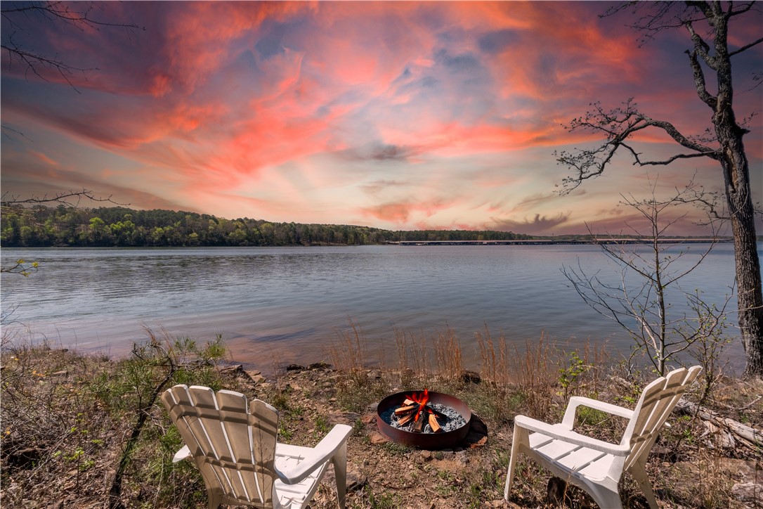 Welcome to your dream lakefront home at a peaceful cul-de-sac, offering privacy and access to Greers Ferry Lake. The main home includes 2 spacious bedrooms, 2.5 baths, an open-concept design, and a covered deck for sunset views. A charming 2-bedroom guest house and a dedicated office in the garage provide extra space. With 120 feet of shoreline for swimming and boating, the property features dramatic cliffs and accessible shoreline. Located near Dam Site Marina, this lakeside retreat is perfect for both full-time living and weekend getaways, offering stunning views and flexible living spaces.