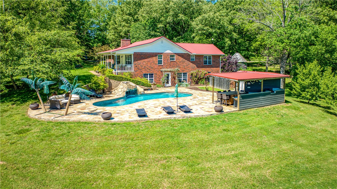 Escape to your own private paradise on this breathtaking 50-acre estate! Nestled along 1/3 mile of year-round navigable Crooked Creek, this sanctuary boasts a luxurious 4-bedroom home complete with an office, theater, and all the comforts you desire. Step outside to discover an entertainer's dream with an inground pool, outdoor kitchen, and serene Koi Pond. For the outdoor enthusiast, bring your fishing pole to reel in the day's catch from the creek or enjoy kayaking and canoeing with convenient access right from your backyard. Bring your four-legged friends, a shop building with 5 stalls ensures they're well accommodated as well as great Hay Production from the Hay Field. More land available MLS H149005