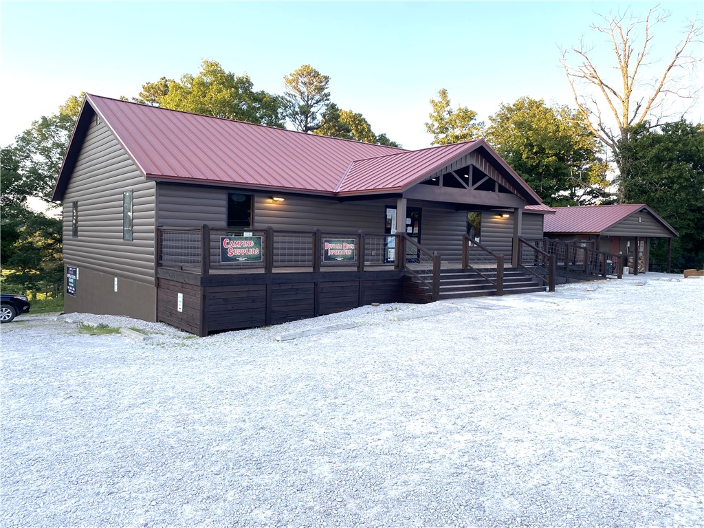 Strategically located at the junction of Hwy 74 & Kyles Landing Rd (5 mi from Jasper) near Kyles Landing Access Point/Campground (2.6 mi) & Triple Falls Waterfall of the Buffalo National River. High traffic count location. Located between Jasper and Ponca and near the Ozark National Forest. Located on 2 ac. The main bldg features 1600SF retail space, 800SF offices/restrooms, 2400SF unfinished basement (with 400SF finished living quarters),1200 SF of decks/porch, 400 amp underground service to the building, Two-5 ton and One-3 ton HVAC, Two-1000 gal septic tanks w/600' of lateral lines. Property includes Bathroom/Coin operated shower house (24 hr access), 1800SF Maint Shop and Koolaire 300 lb ice maker. Business property aluminum Elk Statue and retail inventory. This listing does not include the canoe rental and inventory associated with the canoe rental (canoes, rafts, kayaks, paddles, life vest, vehicles, trailers). The canoe rental (with the real property in this listing) is listed as MLS#1312587.