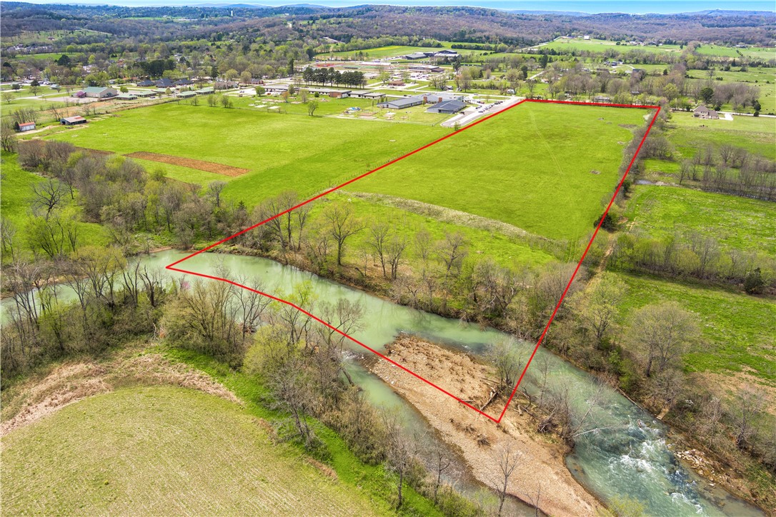 20 Acres of White River Front property in rapidly growing Elkins Arkansas! 470 feet of frontage on State Hwy 16 and over 470 feet of river frontage with a fishing hole that produces great smallmouth and largemouth bass. The majority of the land is in the floodplain or floodway. However, the NW corner of the property by the road is out of the floodplain. This is a spectacular property for recreation. It would also be a great place for a hobby farmer to build a home, have great farmland to tend to and enjoy the river! Zoned A-1 currently in the city of Elkins.