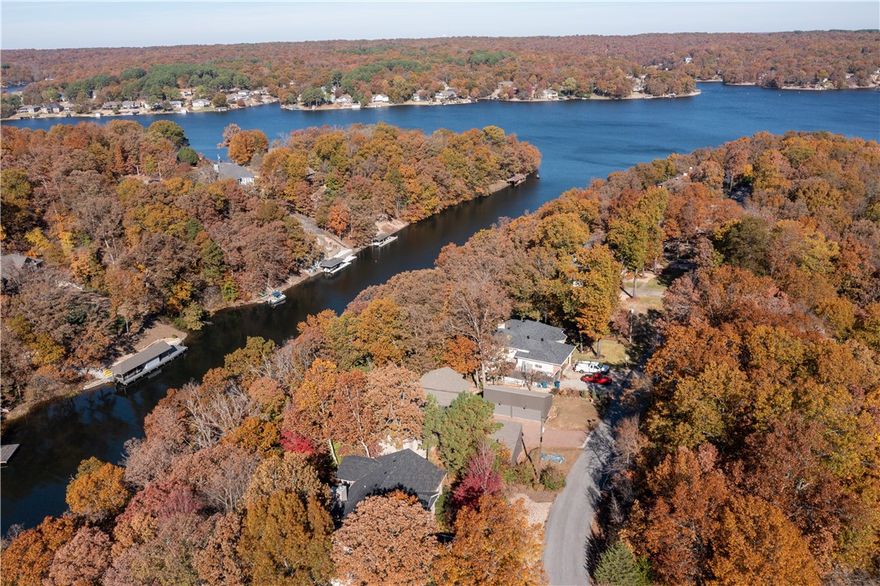 Stunning lakefront retreat on coveted Loch Lomond! This exceptional Bella Vista home offers breathtaking water views, modern updates, and a private dock for boating, fishing, or relaxing. Enjoy a treehouse-like feel from the expansive deck overlooking the lake. Recent upgrades include a luxurious $20K master bath remodel (2024), new recessed lighting, a brand new seawall, interior/exterior paint, a new garage door/opener, and smart security with a Nest system and outdoor cameras. A 3 year old roof (installed October 2022) adds long-term value. Inside, natural light fills the airy living spaces, maximizing stunning lake views. Whether a permanent home or a peaceful getaway, this retreat offers the ultimate lakeside lifestyle. Don’t miss your chance to own a slice of paradise on Loch Lomond. Schedule your private tour today and experience the magic of lakeside living firsthand! Back on market due to absolutely no fault of the seller.