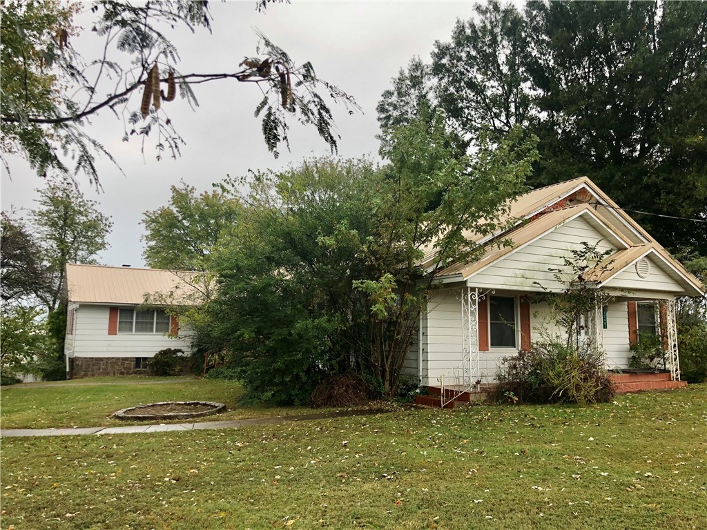 Excellent fixer upper opportunity with space to expand! Large family home with guest house, workshop, and 30x40 steel frame storage building all on 3.9 acres. Property sold as-is.