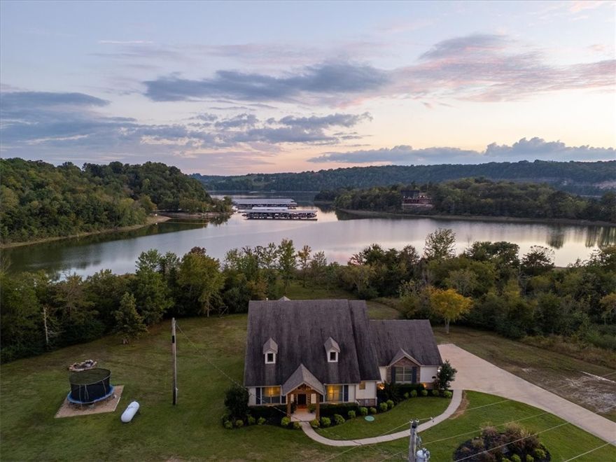 If you're looking for million dollar LAKE VIEWS and effortless LAKE FRONT access right off your back porch, this is the one. This custom-built 2017 lake home is a true unicorn, sitting on three flat acres with a spacious 24X24 shop. Step inside to find soaring vaulted ceilings, a stunning floor to ceiling stone fireplace, an oversized island with quartz countertops, and a large covered back deck overlooking the water. Just imagine the sunsets you'll get to enjoy. The primary suite is located on the main floor and features a spa-like walk in shower and a closet that conveniently connects to the laundry room. Two additional en suite guest bedrooms are also on the main level. Upstairs, you'll find a generous bonus space with a walk in closet, a full bathroom, and an abundance of attic storage. An above ground pool conveys with the home, perfect for summer days spent by the water. With views like these, every day will feel like a getaway while still having easy access to HWY 412 and just 5 minutes to War Eagle Marina.