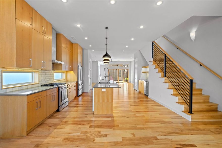 Immaculate and MOVE-IN READY! This modern home offers exceptional downtown Bentonville living in the vibrant Arts & Market District. An abundance of natural light throughout, expansive windows, modern finishes and warm hickory floors create an inviting and sophisticated space. The main level includes: quartz countertops, large island, ceiling-height cabinetry, premium appliances, pantry, coffee/wine bar, dining, 1/2 bath, garage access, nook, storage closet and 2 coat closets. Upstairs, the primary suite offers cathedral ceilings, large windows and a spa-inspired bath with a high-end bathtub and a large walk-in shower. Two spacious bedrooms, a full bath, laundry room, linen closet and a flexible space ideal for a home office make the second floor functional. 2-car garage with ample attic storage. Outdoor living includes a covered composite deck, fenced yard with natural grass and 2 gates.  Located across from Thaden School & minutes from Walmart Home Office, The Momentary, Crystal Bridges & the Bentonville Square.