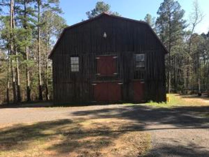 BEAUTIFUL CUSTOM BUILT CABIN, METAL ROOF, CEDAR WALLS UPSTAIRS, NEW CABINETS WITH GRANITE COUNTERTOPS & COMMERCIAL GAS COOK STOVE IN KITCHEN, HIGH CEILINGS, BUILT-INS, HARDWOOD FLOORING,  ALL ON 9.23 ML PRIVATE ACRES WITH A LARGE DECK OVER LOOKING THE POND AND A CIRCLE DRIVE.