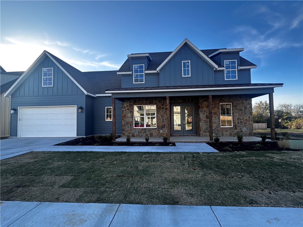 You will love this gorgeous craftsman home in Central Fayetteville's newest development Dutton Woods! The finishes inside and out were hand-picked by our thoughtful design team! You will love the flow of this plan with its office in the front of the home, huge covered porches front and rear, open concept kitchen with huge walk-pantry. The primary ensuite has a rear patio door, dual walk-in closets, dual vanities, full-tiled walk-in shower with a frameless glass door, and a soaker tub! The solid wood treads lead you upstairs to a large bonus/game room, a jack and jill bath shared by two bedrooms, and another large bedroom with a full bath that could be also used as an extra bonus space. The location is amazing and convenient to all of the amenities in town and is only a short drive to I-49 to head north or south. This is a 12-lot neighborhood on a quiet cul-de-sac street located in Root School zone of the Fayetteville school district and within walking distance of Woodland Junior High!