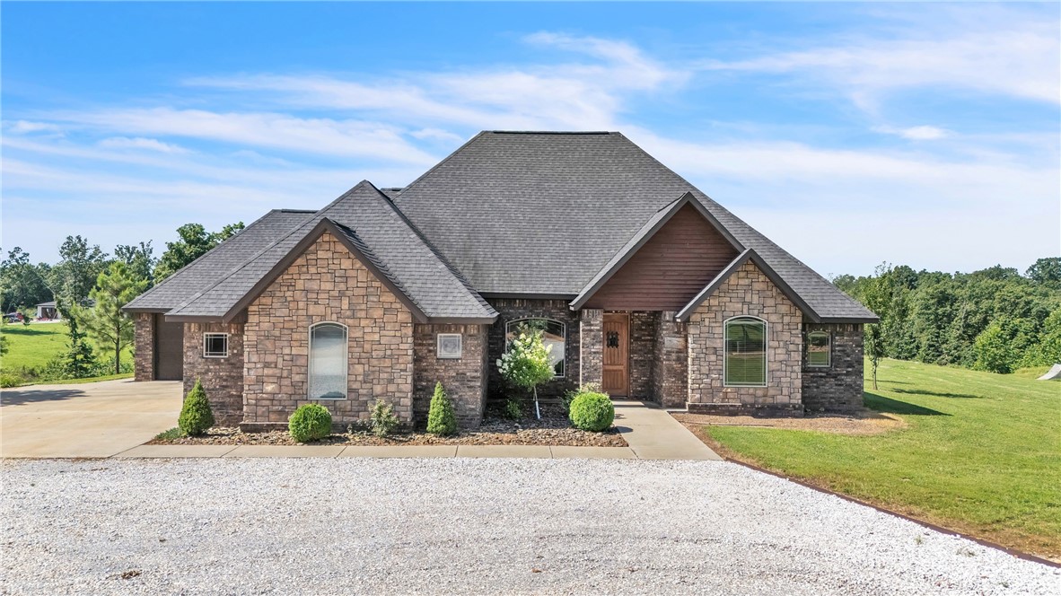 Tucked away on 3 +/- acres in Gravette, 16135 Pembleton Ranch Road offers the space, comfort, and flexibility you've been dreaming of—just minutes from I-49 for easy access to everything Northwest Arkansas has to offer. This 3-bedroom, 2 full bath, 2 half bath home features a spacious open kitchen, split floor plan, and a large primary suite with a walk-in shower, whirlpool tub, and a massive walk-in closet. Upstairs, you’ll find a versatile bonus room with its own mini-split system, half bath, and attic access—perfect for guests, a home office, or hobby space. Step outside to enjoy a covered patio that’s ideal for entertaining, along with a 3-car garage and a poured concrete slab ready for your next big project—whether it’s a shop, sport court, or something custom. With room to spread out and features built for both comfort and convenience, this Gravette gem is ready to welcome you home.