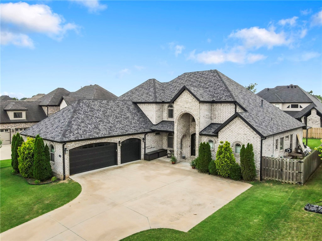 Experience refined living in this move-in ready 4,343 sq ft home in the desirable College Place Neighborhood—just 6 minutes to the new Wal-Mart Home Office & 9 minutes to downtown Bentonville. With 5 bedrooms, 3 full baths, and a half bath across two levels, this home blends luxury and function. The ideal floorplan features a split layout on the main level with a private primary suite and two bedrooms connected by a Jack-and-Jill bath. Upstairs offers two more bedrooms and a spacious bonus/media room with built-in wet bar and wine bar—perfect for entertaining. The open living area is filled with natural light and flows into a chef’s kitchen with granite counters, gas range & pot filler. Enjoy soaring ceilings and a sunroom off the living area, ideal for relaxing. Other features include a brand-new roof (2024), 3 Lennox Aire-Flo HVAC units, TP-Link smart lighting, & high-speed AT&T Fiber internet. Don't forget to check out all the storage & the 3 car garage with epoxy & insulated garage doors! Bentonville Schools!
