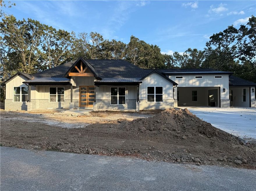 Enjoy Space, Privacy, and Nature Just 20 Minutes from Bentonville. 

Escape the city without sacrificing convenience. This stunning home offers the perfect blend of privacy and accessibility. Tucked on a wooded 1.36-acre lot, you'll enjoy the peace of nature, mature trees, and the space to truly spread out. Inside, the home features 4 spacious bedrooms and 3 full bathrooms, thoughtfully designed to maximize every square foot. The oversized garage gives you room for storage or a workshop, while the 10 ft ceilings in the living area and the expansive entryway with 8 ft double front doors create a grand, welcoming feel from the moment you walk in. 

Luxury vinyl plank flooring runs throughout the home, adding both durability and style. Step outside and relax on not one but two covered patios in the front and back, ideal for morning coffee or evening wind downs surrounded by nature.This property brings the best of both worlds. Peaceful living with modern luxury just minutes from town.